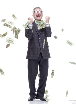 in full growth. happy man standing in the rain of money. isolated on a white background