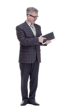 in full growth. smiling man pointing at the screen of a digital tablet. isolated on a white background