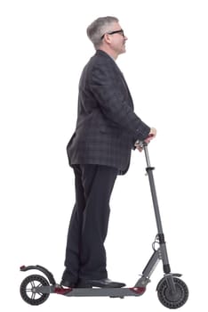 side view. a man with an electric scooter pointing at a white screen. isolated on a white