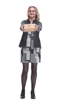 in full growth. happy young woman holding out a gift box. isolated on a white background