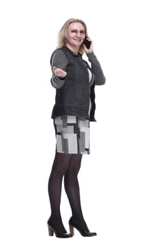 in full growth. a young woman with a smartphone reading an ad. isolated on a white background