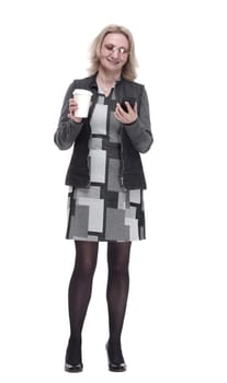 in full growth. casual a young woman with a smartphone drinks coffee to take away . isolated on a white