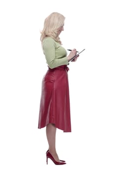 side view. a smiling woman puts her signature on the clipboard . isolated on a white background