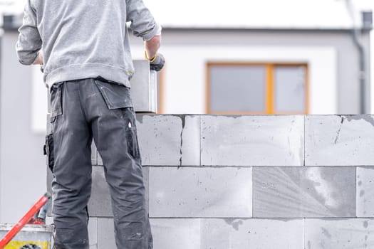 construction of a wall of a house made of concrete bricks. High quality photo