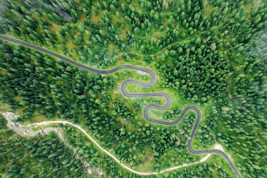 The renowned Snake Road winding through the picturesque Giau Pass, adorned with a breathtaking summer landscape