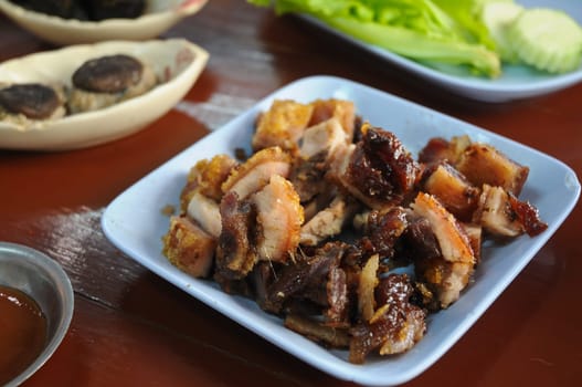 Thai style BBQ Roasted pork in blue dish for lunch