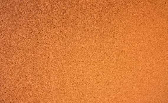 Orange rough concrete wall texture background. Empty orange concrete wall abstract background. Full frame orange cement wall texture background. Blank grain stucco wall. Orange concrete material.