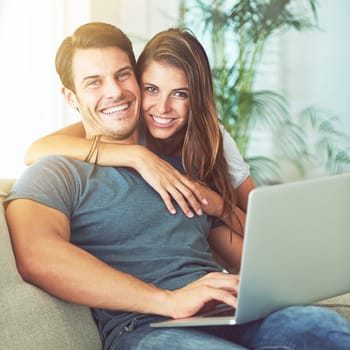 Just being together is bliss. a young couple using a laptop at home