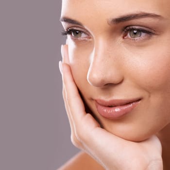 Seeing her beauty close up. Beauty shot of a beautiful young woman with perfect skin against a gray background