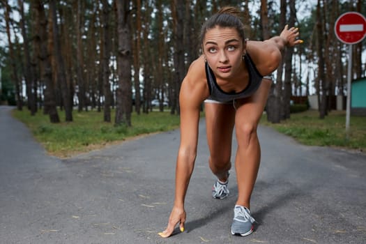 Young woman running outdoors in a city park on. It is preparing to start