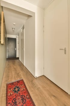 a long hallway with wood flooring and white walls in the room is very clean, but it's hard to see how