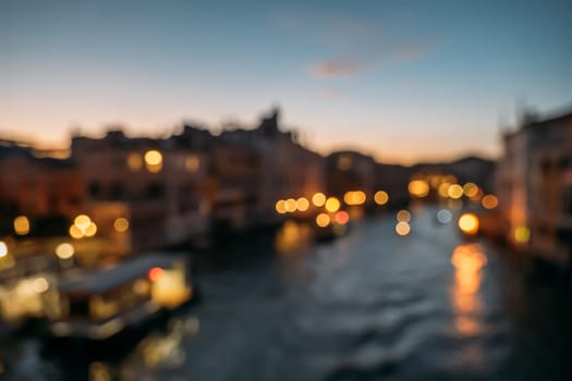 Blurred top view of the Grand Canal in Venice on a cloudless warm summer evening. The concept of attractions in an old European city in Italy. Copyspace.