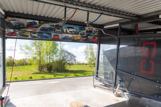 Grodno, Belarus - 28 April, 2023: The interior of the contactless self-service car wash Go on the Belusha str., originally designed in the style of game consoles and decorated with photos of rare cars.