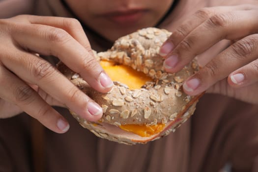 hand holding beef burger on table close up .