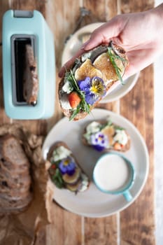 delicious bruschetta with homemade bread, garnished with fig,soft cheese,pansies, top view. High quality photo