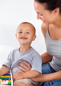 Learning is key to his development. A cute toddler boy looking proud of his achievements