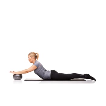 Pushing it down and holding it there. A young woman using an exercise ball while lying down - isolated