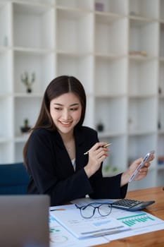 Excited businesswoman using mobile phone while in office , business concepts