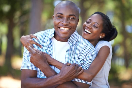 Romance in the great outdoors. Portrait of a young couple sharing a tender moment while out for a walk in the woods