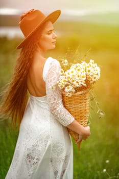 A middle-aged woman in a white dress and brown hat stands on a green field and holds a basket in her hands with a large bouquet of daisies. In the background there are mountains and a lake