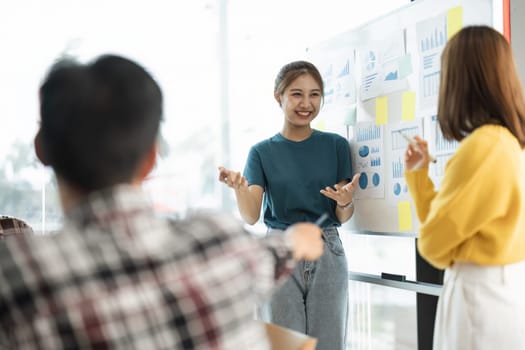 Group of young asian creative business brainstorm meeting presentation, discussing roadmap to product launch, planning, strategy new startup project in office.