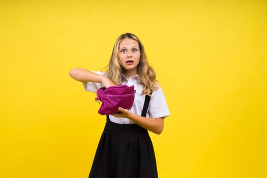 Happy schoolgirl with colored pencils and pencil case in hand