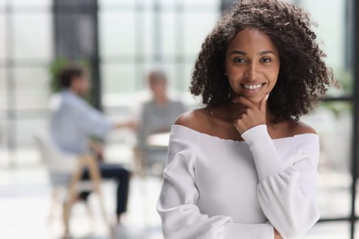 Portrait of an African American young business woman working in the office.