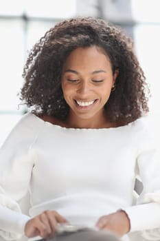 Portrait of a young attractive African American woman using a smartphone.