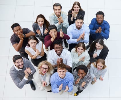 top view. a group of casual young people applauding together