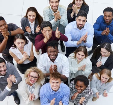 top view. a group of casual young people applauding together