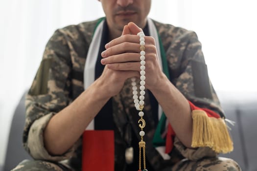 Soldier from United Arab Emirates with prayer beads.