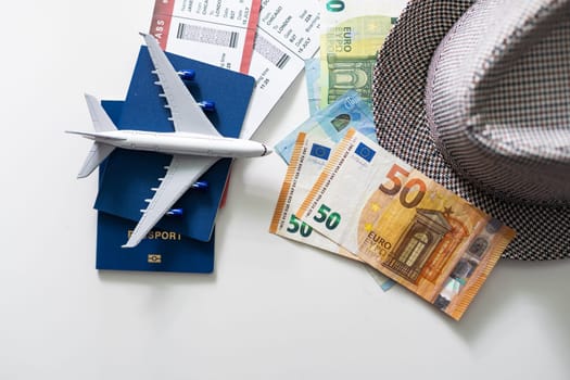 Travel accessories on the light boards. Hat, camera, document holder with passport, glasses.