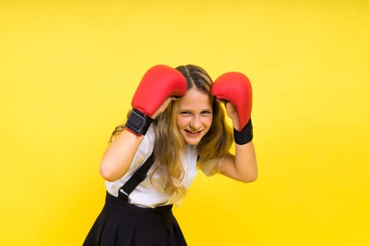 Little girl wearing red boxing gloves, studio shot, sport conception