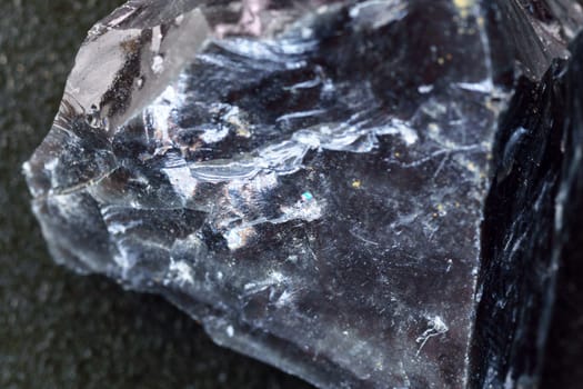 Black Obsidian stone close up macro. Natural glass. Black mineral gem