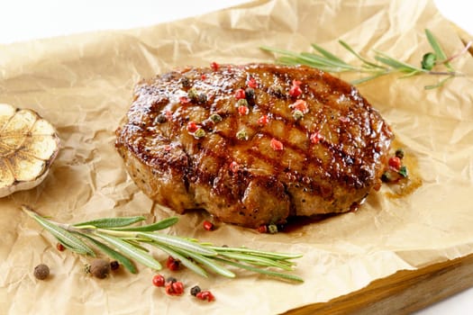 Fried steak close up, tasty, restaurant. Spiced with peppercorns and herbs