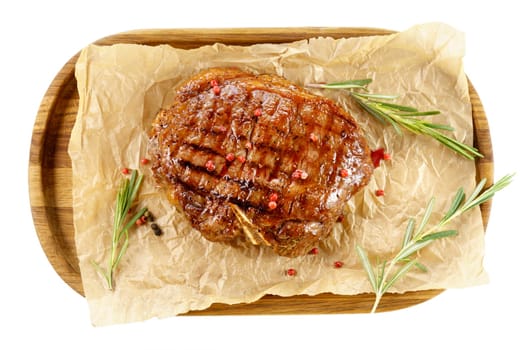 Fried ready-made steak close-up, delicious, restaurant. Seasoned with pepper, peas and herbs. Isolated on a white background