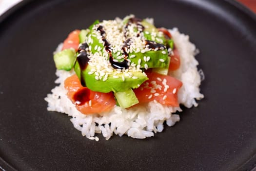 Sushi waffle is a cooking process. Culinary trend made with crispy rice waffles and sprinkled with salmon, cucumber and avocado.