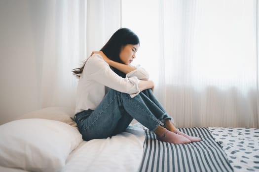 Young attractive asian woman lying at home living room couch feeling sad tired and worried suffering depression in mental health, problems and broken heart concept