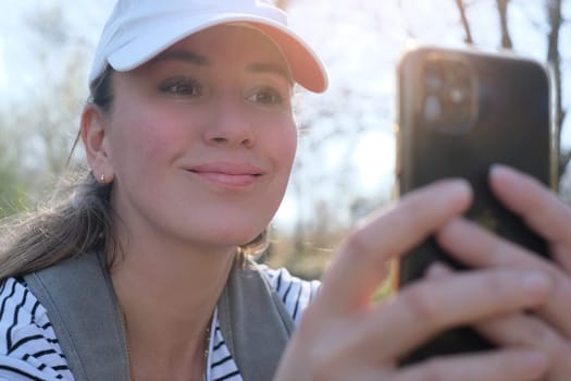 Happy woman traveler with backpack taking selfie during trekking trip in forest.