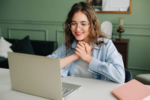 Excited young business woman celebrating success reading laptop screen, receiving good news email with salary growth opportunity.