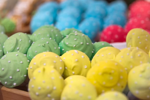 Sweet pastries with rainbow icing in a pastry shop. High quality photo