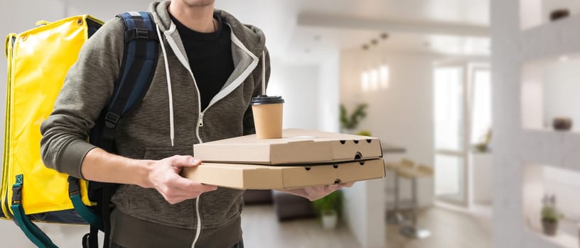 Diverse of paper containers for takeaway food. Delivery man is carrying pizza.