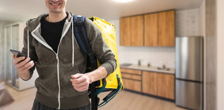 Delivery man with thermal backpack for food. Takeaway food delivery. Man delivering online food orders to customers with thermal bag, grocery deliver