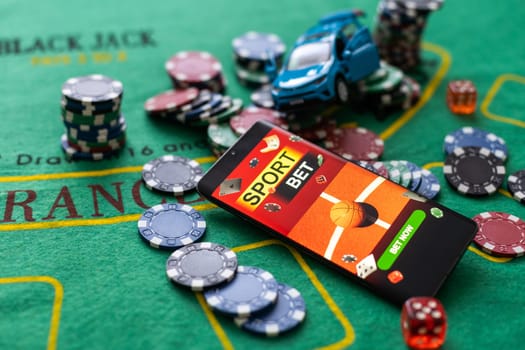 smartphone with betting on sports, casino toy, car.