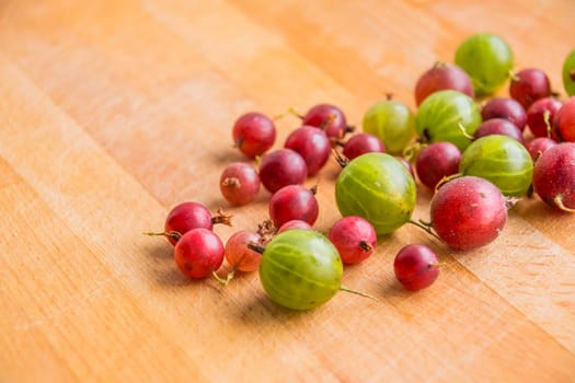red green gooseberry on white
