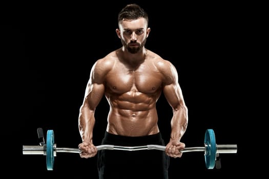 Close up of young muscular man lifting weights over dark background