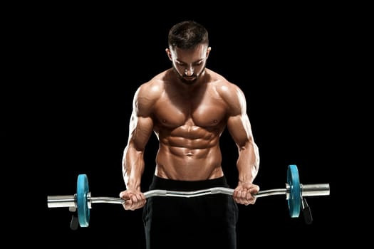 Close up of young muscular man lifting weights over dark background