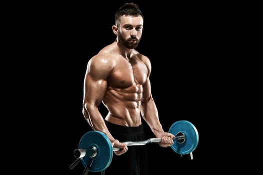 Close up of young muscular man lifting weights over dark background