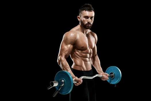 Close up of young muscular man lifting weights over dark background
