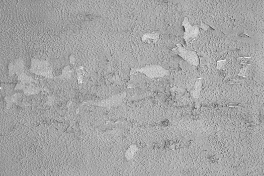 Texture of peeling old gray paint on the wall.